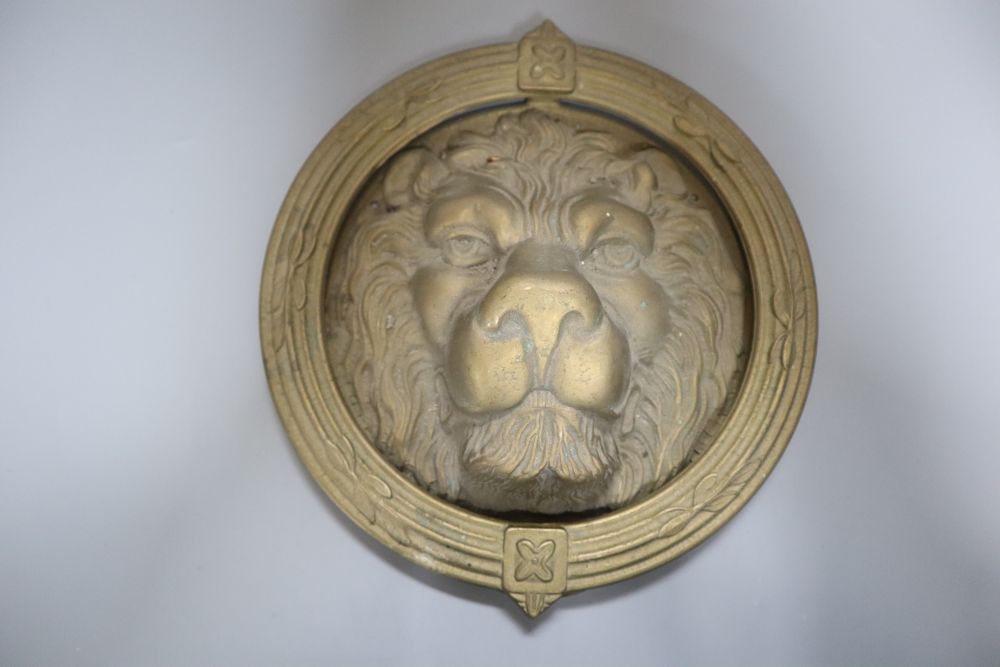 A large cast brass lions head door knocker, diameter 21cm